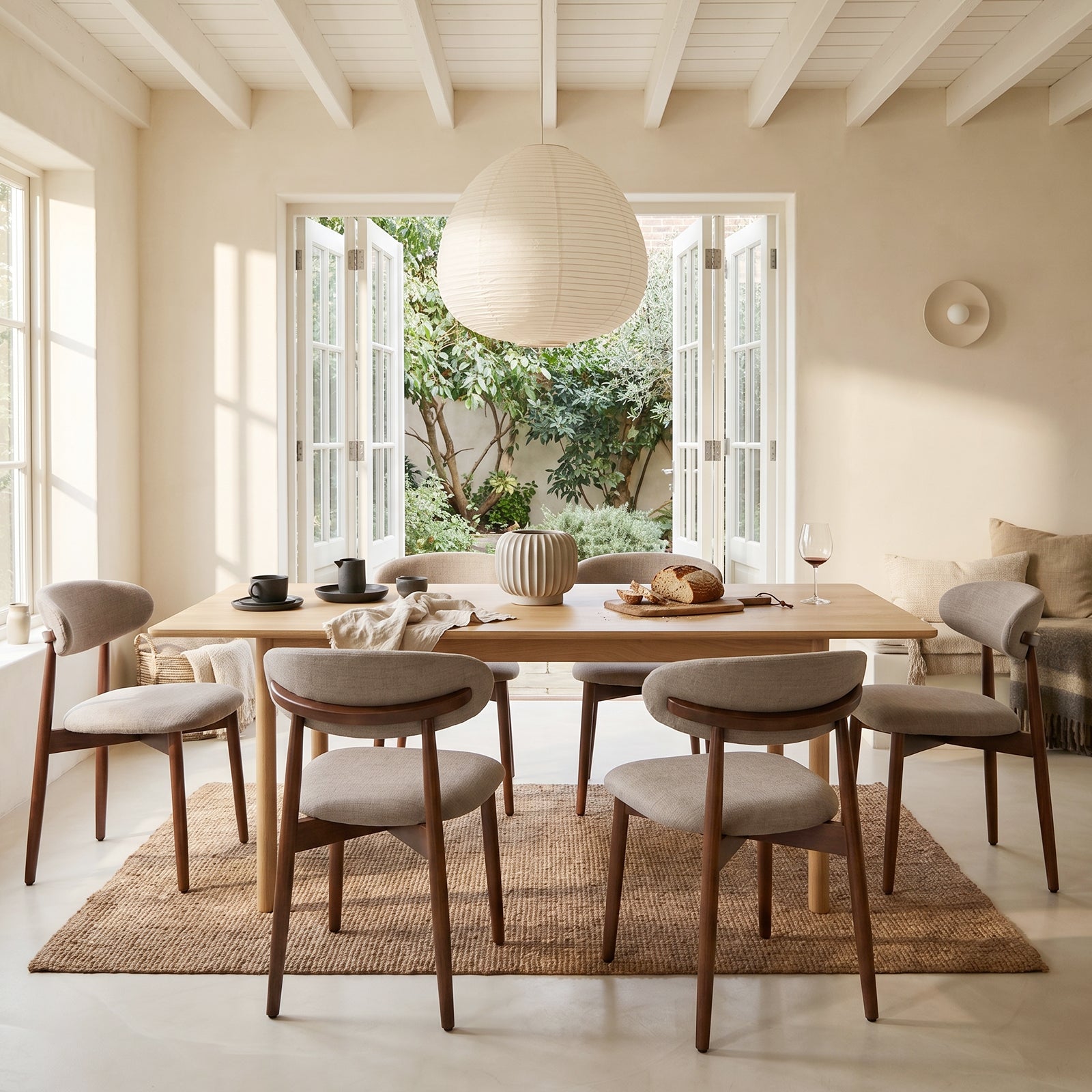 COLAMY NOYA beige dining chairs with curved upholstered backs in a bright open dining space
