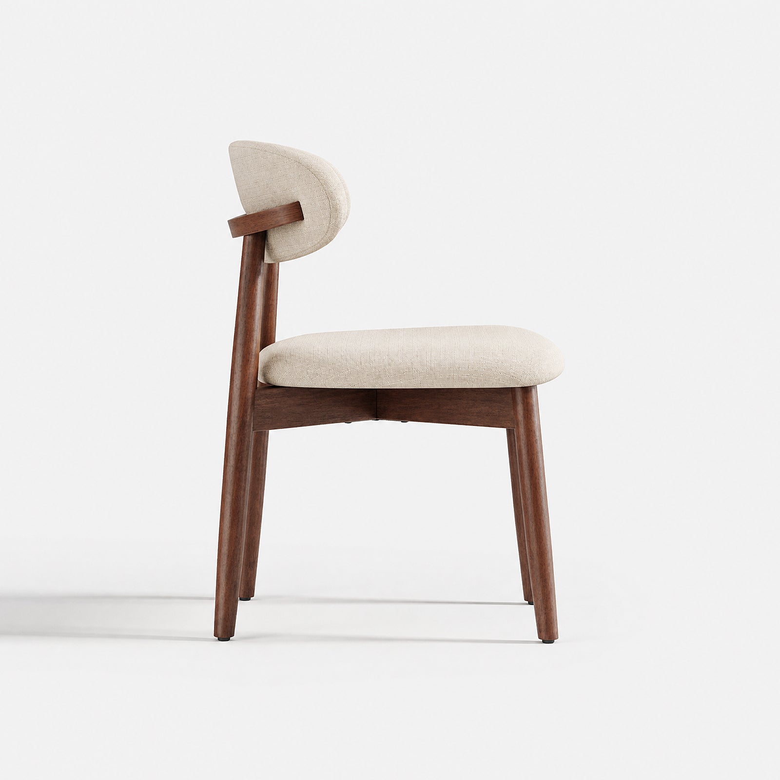 Side view of COLAMY NOYA beige upholstered dining chair with curved backrest