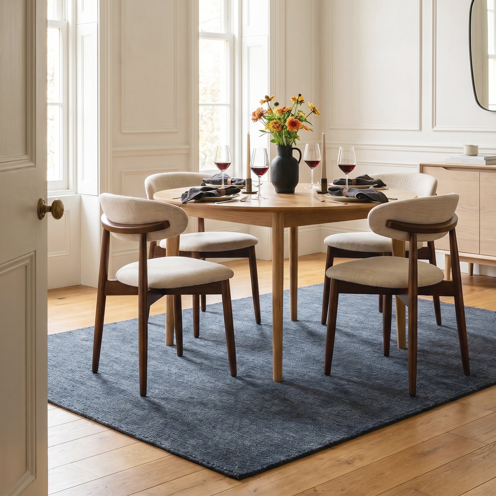 COLAMY NOYA beige fabric dining chairs around a round wooden table in an elegant dining room