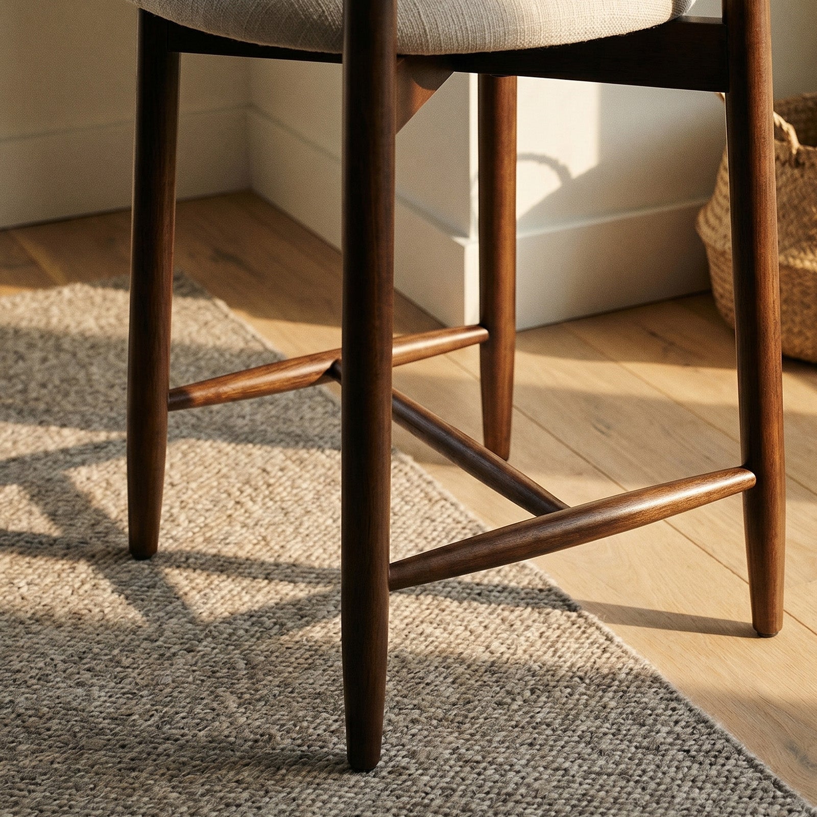 Wooden Colamy upholstered bar stool with a textured cushion on a wooden floor.