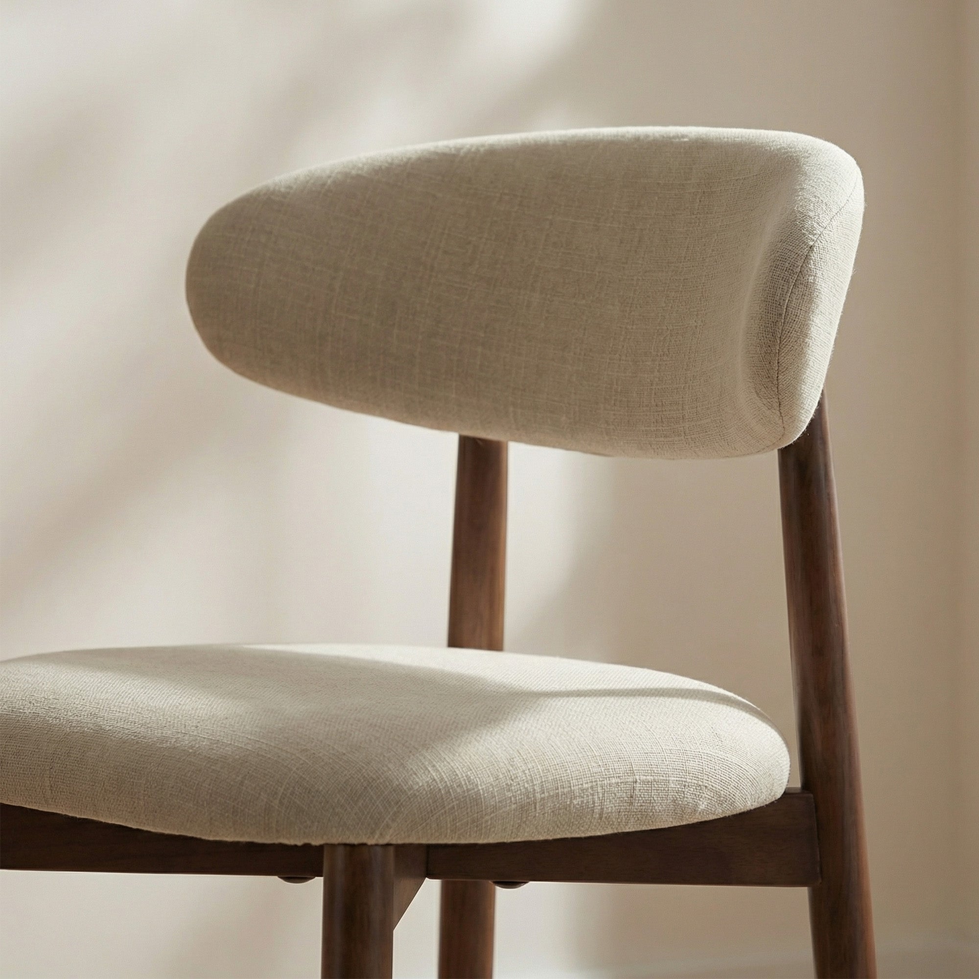 Beige Colamy upholstered Bar Stool with wooden legs against a neutral background