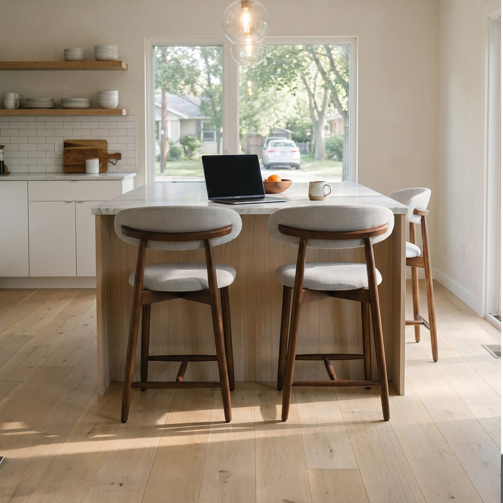 Modern kitchen with Colamy upholstered bar stools, and a laptop.